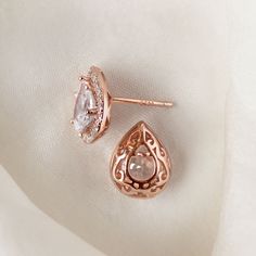 These classic Teardrop / Pear studs boast a spectacular halo of pave crystals that really give off its shine. Complete your bridal look with a sleek back bun to show off your standout style. Rose Gold Vermeil Cubic Zirconia pave crystals Hypoallergenic post Height: 0.5in (1.3cm) x Width: 0.39in (1cm) #E440 Sleek Back Bun, Statement Bridal Earrings, Pearl Earrings Drop, Sleek Back, Bridal Earrings Studs, Bridal Statement Earrings, Round Halo, Choker Pendant, Back Necklace