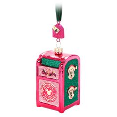 a pink and green christmas ornament with mickey mouse on it's chest