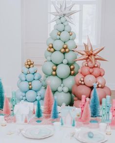 a table topped with balloons and christmas trees