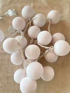 some white balls and string lights on a table