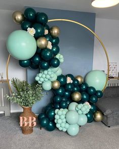 a balloon arch with green and gold balloons