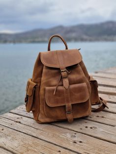 Leather Backpack in waxed brown with side pockets and many compartments in variety of colours and sizes. It's  the ideal Backpack for students and perfect for your travels. All bags are handmade of real Greek leather and brass accessories. The straps are adjustable.   The bag in the picture is a medium (28×34×15 cm) MIND THAT THE COLOURS SOMETIMES MAYBE BE A LITTLE BIT DIFFERENT. All Bags are made to order. If you like this bag, please see our full collection in the below link: https://www.etsy. Brown Waxed Finish Satchel For School, Brown School Satchel With Pockets, Brown Satchel With Pockets For School, Brown Bags With Multiple Pockets For Outdoor Activities, Leather School Backpack With Pockets, Brown Backpack With Pockets For Everyday Use, Waxed Finish Satchel Backpack For School, Brown School Backpack With Pockets, Brown Shoulder Bag With Pockets For Adventure