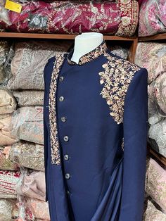 Navy blue sherwani enriched with delightful zari and thread and stone work. Sherwani is beautified with embroidered lycra draped dupatta. Available with matching trouser. Size: 38,40,42,46 Occasion: Wedding Ceremony or Reception WASH CARE INSTRUCTIONS - Please Dry clean only when it is applicable. Slight color variation is possible due to digital photography. Ready to Ship! Teal Sherwani, Navy Blue Sherwani, Blue Sherwani, Ceremonial Clothing, Wedding Trousseau, Wedding Suit, Stone Work, Wedding Suits, Digital Photography