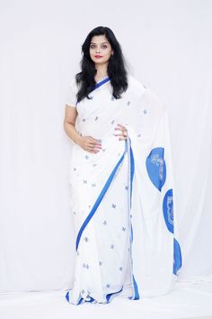 Wearing this beautiful crepe saree will help you unleash your inner diva. The edges of the plain white saree are embellished with a simple yet graceful blue border. Its peaceful white and the blue combination will help you feel peaceful and serene with yourself. To make it look the brightest, dress it up with complementing accessories and stilettos. Specifications: 1) Blouse Color- White & Blue 2) Blouse Length-80 cm(Unstitched) 3) Saree Length-6.5 m 4) Care Instructions- Dry Clean only. 5) Saree Colors Available- White color saree with blue design & blue color saree with white design 6) Colors available-white and blue 7) Width-45 inches 8) Fabric type- Crepe 9) Print Type- Digital Print 10) Brand name- Mudita by Lejina 11) Conceptualized and Created in- India 12) Make sure- You are not wa Traditional White Pre-draped Saree With Embroidered Border, White Cutdana Pre-draped Saree For Puja, White Semi-stitched Saree With Printed Motifs, Festive White Saree With Printed Motifs, White Bollywood Saree With Printed Motifs, White Blouse Piece With Printed Motifs In Traditional Drape, Blue Georgette Saree With Embroidered Border, White Dupatta With Printed Motifs For Festivals, White Blouse Piece With Printed Border