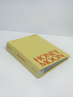 a yellow book sitting on top of a white table