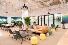 an office lobby with couches, tables and chairs