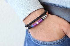 A modern leather bracelet featuring hand-woven leather cord in blue, purple, off-white and black. Finished with a secure magnetic clasp in matte black. Details: - Genuine leather cord in brown - Woven leather cord - Wool & cotton - Secure magnetic clasp in matte black For additional information, please feel free to contact us. Handmade Modern Black Braided Bracelets, Handmade Modern Black Braided Bracelet, Modern Blue Leather Bracelet Gift, Modern Purple Bracelet As Gift, Handmade Modern Wrap Bracelet As Gift, Modern Handmade Wrap Bracelet As Gift, Modern Handmade Wrap Bracelet For Gift, Handmade Modern Wrap Bracelet Gift, Mens Leather Jewelry