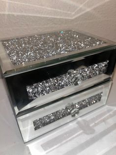 a clear box with silver glitter on it