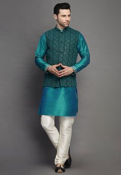 Art Silk Kurta in Teal BlueThis Readymade attire is Enhanced with Buttons, Resham and Sequins Work. Crafted in Chinese Collar Neck and Full SleeveAvailable with an Art Silk Churidar in Off White and a Faux Georgette Nehru Jacket in Dark GreenDo note: Footwear shown in the image is for presentation purposes only. Half to one inch may vary in measurement. (Slight variation in actual color vs. image is possible) We sell all kinds of menswear. Mens Kurta | Mens Kurta Pajama | Mens Sherwani | Mens Sh Blue Bandhgala With Floral Embroidery And Long Sleeves, Traditional Blue Sets With Embroidered Sleeves, Blue Floral Embroidered Bandhgala For Designer Wear, Festive Blue Bandhgala With Floral Embroidery, Traditional Fitted Outerwear With Embroidered Sleeves, Fitted Blue Nehru Jacket For Designer Wear, Fitted Blue Nehru Jacket For Designer Events, Traditional Blue Kurta With Embroidered Sleeves, Fitted Blue Nehru Jacket With Floral Embroidery