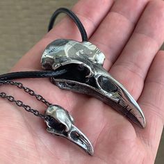 Raven Skull Necklaces - Pewter Two Sizes to Choose From! Pendant: PewterApprox. Sizes: Small: 0.6" wide x 1.1" tall x 0.5" depth, 6 grams.X-Large: 1.1" wide x 2.4" tall x 0.6" depth, 38 grams.Necklace: Small gets a 21" black chain, Large gets a 24" black 3mm cord. Worldwide shipping available!US Customers: Typically ships in 1 business day, delivers in 2-5 days.Outside of US: See shipping options during checkout.Share on social media: Halloween Engraved Metal Necklace, Halloween Stainless Steel Pendant Jewelry, Adjustable Themed Sterling Silver Necklace, Symbolic Pewter Jewelry For Collectors, Adjustable Gunmetal Nickel-free Necklace, Adjustable Nickel-free Gunmetal Necklace, Adjustable Pewter Jewelry As Gift, Silver Themed Pendant Jewelry, Themed Silver Pendant Jewelry