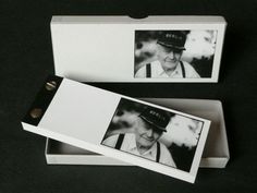 an old man wearing a hat and suspenders is in a box with the lid open