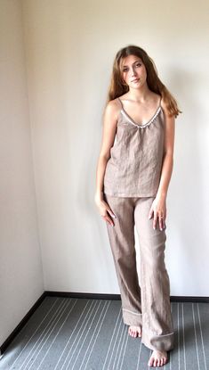 This trousers and top pajama set is made from stonewashed linen. Two side seam pockets and contrast piping make this stylish pant both comfortable and functional. Elastic waistband for a comfy, adjustable fit. The wide legs will give you a high fashion feel. Camisole top on straps and laces. Just try it and you will love it. These PJs are a fantastic choice as a gift for a friend or yourself - you'll be having sweet dreams with this beautiful set. The total length of trousers is around 105 cm, i Casual Linen Sleepwear For Pajama Party, Summer Linen Lounging Sets, Casual Linen Sets For Relaxation, Linen Sleep Sets With Relaxed Fit, Relaxed Linen Sleep Set, Linen Relaxed Fit Sleep Set, Relaxed Fit Linen Sleep Set, Linen Beach Pants, Linen Pajamas