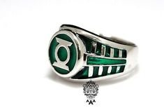 a green and white ring with the letter o on it's center, sitting in front of a white background