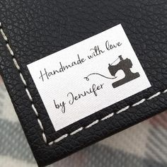 a black leather wallet with a white stitching on it and a label that says handmade with love by denver