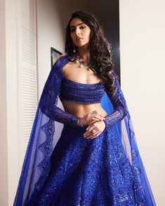 The electric blue Mirielle lehenga set is a reception bridal 12 kalis set with heavy floral geometric embroidery through out each kalis. Paired with a heavily floral embroidered bustier blouse with side cuts, and paired with a silk organza scallop floral dupattaDELIVERY TIMEPlease allow 8-12 weeks for your outfit to arrive.FABRIC DETAILSPure Raw silk top and lehenga Silk organza dupattaProfessional cleaning only. Lehenga Designs Royal Blue, Electric Blue Lehenga, Royal Blue Indian Outfit, Blue Indian Outfit, Lehenga Silk, Royal Blue Lehenga, Top And Lehenga, Bustier Blouse, Latest Lehenga Designs