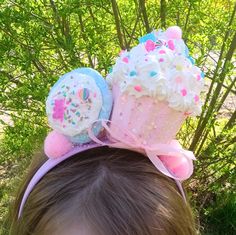 This Headband/Fascinator is such a cutie!! 🥰. What is more fun than a colorful Cupcake and a Sugar Cookie to go along with it 🍪🧁 ** This can be made to fit both Kids and Adults!   Please choose a size at checkout! ** You can also choose the color of your headband at checkout! 🧁 The cupcakes it's about 4.5 inches high and is done with fake icing, candy charms which will vary, chunky glitter and some sprinkles.    * Everything is then sealed! 🧁 The fake sugar cookie is done in light blue with white icing and  some candy charms. Everything is very very secure!  I do take custom orders if you would like to change the color scheme.  Thank you so much for visiting my shop and I am here with any questions! Fake Icing, Pinkie Pie Cosplay, Cupcake Costume, Candy Charms, Headband Fascinator, Colorful Cupcakes, Maternity Sash, Diy Desserts, Crazy Hats