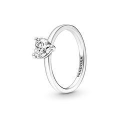 The latest addition to our solitaire collection, the Sparkling Heart Solitaire Ring features a heart-shaped clear cubic zirconia as the centerpiece. The Pandora logo is engraved on the inside of the polished shank. Stack this ring with other sterling silver pieces for a monochromatic look or mix metal finishes to make a unique statement. Classic Sterling Silver Heart Ring With Brilliant Cut, Classic Solitaire Heart Ring With Cubic Zirconia, Silver Heart Cut Single Diamond Ring, Silver Heart Cut Ring With Single Diamond, Classic Heart Ring With Vs Clarity Cubic Zirconia, Classic White Gold Heart Ring With Solitaire, Classic Solitaire Heart Ring In White Gold, Classic Heart Promise Ring, Classic Solitaire Heart Ring For Formal Occasions