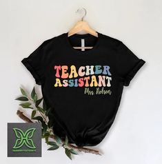 Personalized Teacher Assistant Tee,Teaching Assistant Gift,Substitute Teacher Appreciation Shirt,Teacher Aide,School Paras Team,Paraeducator HOW TO ORDER 1. From the two Drop-down menus select the Size and the Shirt Color you need. 2. Add these to your cart. *You will need to return to the listing to add the other sizes and designs you need before checking out. 3. After adding all the shirts to the Cart, Checkout them together. DELIVERY & RETURN Order Processing time for Dispatch: 1 working days Teacher Assistant Shirts, Substitute Teacher Appreciation, Teacher Aide, Teachers Aide, Teacher Assistant, Teaching Assistant, Substitute Teacher, Teacher Shirts, Teacher Appreciation