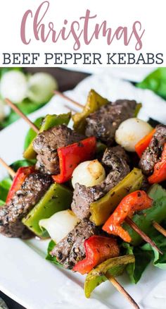 christmas beef kebabs with peppers and onions on a white plate