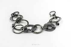 Raw Silver chain bracelet Handmade. This bracelet's links are crafted in different sizes, with a very interesting texture. Get a 10% discount off your next order by subscribing at Diapiro's newsletter. Link for coupon code https://mailchi.mp/56f529763263/diapiro All of my products are carefully handmade with authentic techniques of Goldsmithing such as Sawing - Forming - Rasping - Sanding - Soldering - Engraving- Hammering - Enameling- Setting Gemstones and many more. ~~ PACKAGING: Your jewelry Handmade Unique Sterling Silver Bracelet, Unique Metal Bracelet With Oxidized Finish, Modern Hand Forged Metal Bracelet, Unique Round Bracelets With Oxidized Finish, Handmade Adjustable Link Chain Bracelet, Unique Metal Chain Bracelet, Handmade Adjustable Oval Link Chain Bracelet, Handmade Metal Fusion Bracelets, Metal Link Bracelets With Oxidized Finish