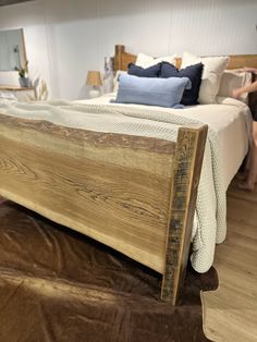 a wooden bed frame sitting on top of a hard wood floor