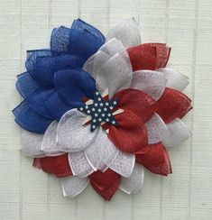 a red, white and blue flower made out of mesh