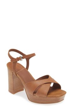 Crisscrossing vamp straps create modern dimension on a lofty leather sandal set on a stacked platform and towering block heel. 3 3/4" heel; 1 1/4" platform (size 8.5) Adjustable ankle strap with buckle closure Leather upper and lining/synthetic sole Imported Spring Cross Strap Sandals With 4-inch Heel, Leather Cross Strap Heels With Padded Heel, Leather Cross Strap Heels With Wrapped Heel, Leather Cross Strap Heels With Heel Loop, Leather Heels With Wrapped Heel And Cross Strap, Modern Brown High Heel Block Heels, Leather Sandals With Padded Heel And Cross Strap, Leather Sandals With Stacked Heel And Cross Strap, Leather Cross Strap Sandals With Stacked Heel