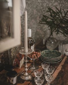 a table topped with plates and glasses filled with food