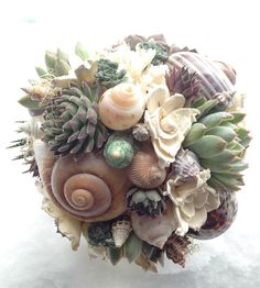 a bridal bouquet with seashells and succulents