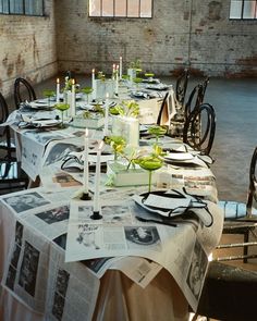 a long table is set up with newspaper and candles for an elegant dinner party or celebration