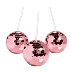 three shiny pink balls with white sticks sticking out of them