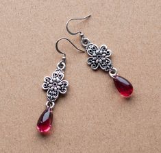 These beautiful earrings are made from dark red, teardrop shaped glass crystals attached to intricate filigree connectors. They will make a beautiful accessory for someone who loves Victorian or vintage style accessories. -The earrings are 1.75 inches long, without the closure/ear wire -Stainless steel French hooks -Light weight materials SHIPPING: CANADA: Default shipping within Canada is by letter mail, no tracking, takes 1-2 weeks USA: Tracked Packet, includes tracking : 1-2 weeks Europe: Def Ornate Red Teardrop Jewelry, Dark Red Crystals, Corset Choker, Timeless Earrings, Black Lace Choker, Vintage Drop Earrings, Formal Jewelry, Gothic Earrings, Victorian Vintage