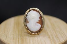 Precious Bezel set Shell cameo ring. Set in 10k yellow gold. Vintage made before middle of century. Marked BDA - Budlong, Dockert & Armstrong Condition: shows signs of wear consistent with old age. Details 3.7grams total weight 10k gold and carved shell 20mm by 15mm rectangle cameo Antique 14k Gold Signet Ring With Cabochon, Antique Carved Yellow Gold Signet Ring, Formal Carved Signet Ring In 14k Gold, Carved 14k Gold Signet Ring For Formal Occasions, Classic Carved Yellow Gold Jewelry, Carved Signet Ring In 14k Gold For Formal Occasions, Vintage Carved Yellow Gold Rings, Elegant Carved Signet Ring For Formal Occasions, Victorian Yellow Gold Oval Cabochon Jewelry