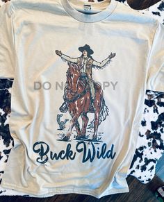 Buck Wild cowgirl graphic tee - Mavictoria Designs Hot Press Express Cowgirl Graphic, Medium Long, Fall Thanksgiving, Holiday Collection, Workout Tee, Graphic Tee, Crew Neck Sweatshirt, Graphic Tees, Sweatshirts