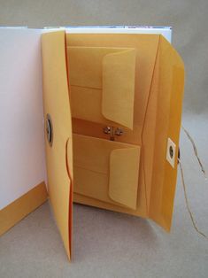 an open yellow folder with two compartments on each side