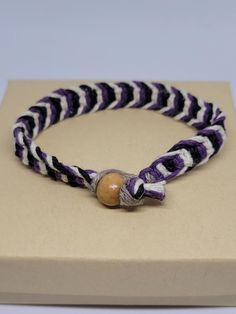 Knotted by hand in a fishbone style pattern with black, purple and white, dyed hemp cord. This bracelet is not adjustable. Wood bead and loop closure. Metal free, allergy friendly! 6 inches long. Ready to ship! All sales final. Casual Black Woven Friendship Bracelets, Casual Purple Bracelets With Sliding Knot, Handmade Casual Purple Bracelets, Casual Purple Braided Bracelet As Gift, Casual Handmade Purple Bracelets, Casual Purple Handmade Bracelets, Casual Purple Braided Bracelets For Beach, Adjustable Purple Braided Bracelet, Adjustable Purple Friendship Bracelets