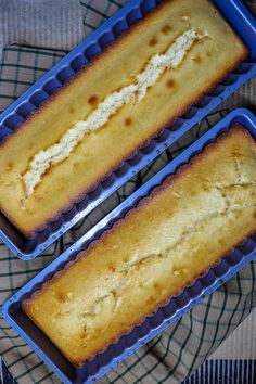 two blue trays filled with cake next to each other