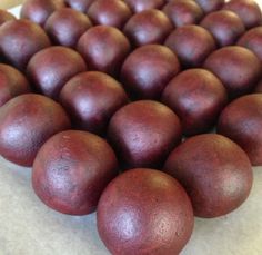 a bunch of red fruit sitting on top of a white countertop next to each other