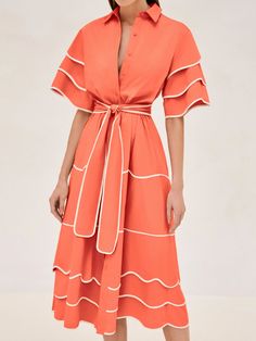 Introducing the Rhodes Midi Dress. This dress features a vibrant orange hue that instantly brightens your wardrobe, while the playful, layered trim detailing adds a touch of flair to its classic shirt dress silhouette. Finished with a flattering waist tie to accentuate your figure, this will become your go to for chic and comfortable summer dressing. Fitted Belted Tiered Dresses, Chic Orange Dresses With Ruffles, Orange Maxi Dress With Ruffles And Short Sleeves, Orange V-neck Midi Dress With Ruffles, Orange Belted Summer Dress, Chic Orange A-line Midi Dress, Orange Tiered Dress For Brunch, Ruffled Midi Shirt Dress For Work, Orange V-neck Midi Dress For Work