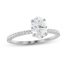 an oval cut diamond ring with pave set shoulders