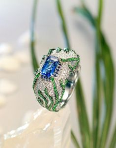 * Condition: Brand new * Center Stone: Natural Blue Sapphire, Emerald Cut, approx 2.08ct * Side Stone: Natural Tsavorite & Natural White Diamonds, round cut * Ring weight: 17.35g (actual weight depends on the ring size) * Metal Purity: 18K Solid White Gold (Optional) * Free DHL Express shipping. * Attached with Certificate. * Each piece is made-to-order with care and special attention to detail. all items are made with conflict-free diamonds and gems. * The item will be gift wrapped and shipped. Luxury Green Sapphire Ring With Accent Stones, Luxury Green Sapphire Ring With Diamond, Luxury Green Sapphire Ring For Anniversary, Luxury Green Sapphire Anniversary Ring, Luxury Green Sapphire Ring Gift, Luxury Green Sapphire Jewelry, Gold Engagement Ring Sapphire, Engagement Ring Sapphire, Luxury Jewelry Box