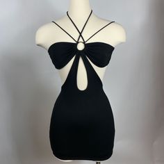 the back of a black dress with a large bow on it's neckline