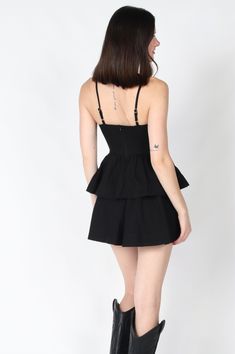 The Novie Mini Dress is your go-to little black dress for an unforgettable night out. Featuring delicate spaghetti straps and a playful tiered design, this sleek black dress effortlessly combines elegance with a hint of fun. Perfect for dancing the night away or making a statement at any evening event! Color: Black Self: 100% Cotton, Lining: 100% Cotton Hand wash cold, hang to dry. Item #2404-73LDJ Please call for in-store availability Size/Fit Model is wearing size S. Black Strap Mini Dress For Cocktail, Black Strappy Cocktail Mini Dress, Black Mini Dress With Adjustable Straps For Party, Strapless Suspender Dress With Ruffles For Party, Evening Suspender Dress With Spaghetti Straps And Ruffles, Flirty Ruffled Suspender Dress For Party, Elegant Tiered Skirt Mini Dress For Night Out, Elegant Mini Dress With Tiered Skirt For Night Out, Elegant Tiered Mini Dress For Night Out