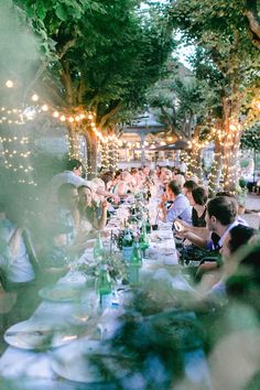 a group of people sitting around a dinner table