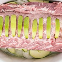 sliced meat and vegetables in a white bowl