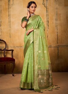 Unleash your funky side with our Pista Green Zari Weaving Tissue Silk Saree! The unique Latakan on the Pallu and beautiful contrast Mehndi Blouse make it perfect for any festive occasion. Say goodbye to boring sarees and hello to playful and quirky fashion! The unstitched blouse can be customized upto 44 inches. Do Note: All the accessories shown are for styling purpose only. Slight color variation may occur due to photographic reasons. Fall and Pico : Done Drapping Saree(Ready to wear) : On Req Buy Blouse, Jacquard Saree, Tissue Saree, Green Saree, Net Saree, Party Kleidung, Art Silk Sarees, Organza Saree, Silk Sarees Online