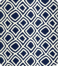 a blue and white rug with an abstract design