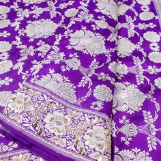 Explore Aayna from Khinkhwab: A captivating collection of hand-embroidered sarees that beautifully blend traditional craftsmanship with contemporary elegance. Embroidered Purple Banarasi Silk Traditional Wear, Traditional Purple Unstitched Suit With Drape, Traditional Purple Embroidered Fabric, Embroidered Jamawar Traditional Wear For Puja, Pre-draped Saree With Traditional Patterns For Ceremonies, Embroidered Purple Traditional Wear For Ceremonial Use, Dola Silk Fabric With Zari Weaving For Puja, Banarasi Silk Embroidered Saree Fabric For Puja, Dola Silk Embroidered Fabric With Zari Weaving For Puja