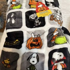 a blanket with halloween pictures on it and a tag attached to the back of it