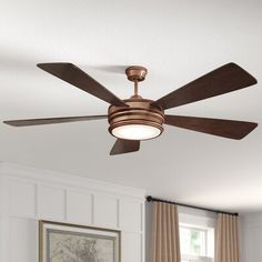 a ceiling fan that is hanging from the ceiling in a room with white walls and curtains